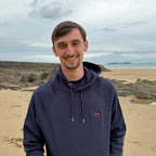 French marine Overcut hooded sweatshirt with Jeep Wrangler embroidery, worn on a beach